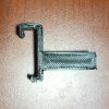 Photograph of the 4040 snap on clip. Both ends are hook shaped, with the hook on the bottom less deep. This print has a long tab opposite the hooks to allow the clip to be pried out of the extrusion.