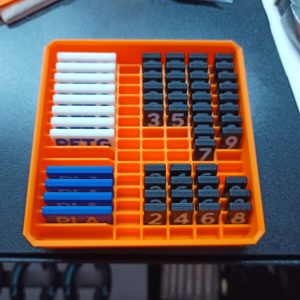 A FreeGrid box with partitions for digits and labels.