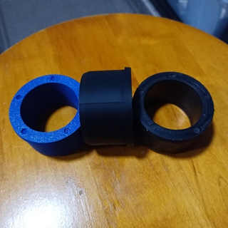 Replacement roller parts, original on right, replacement parts in blue and black.